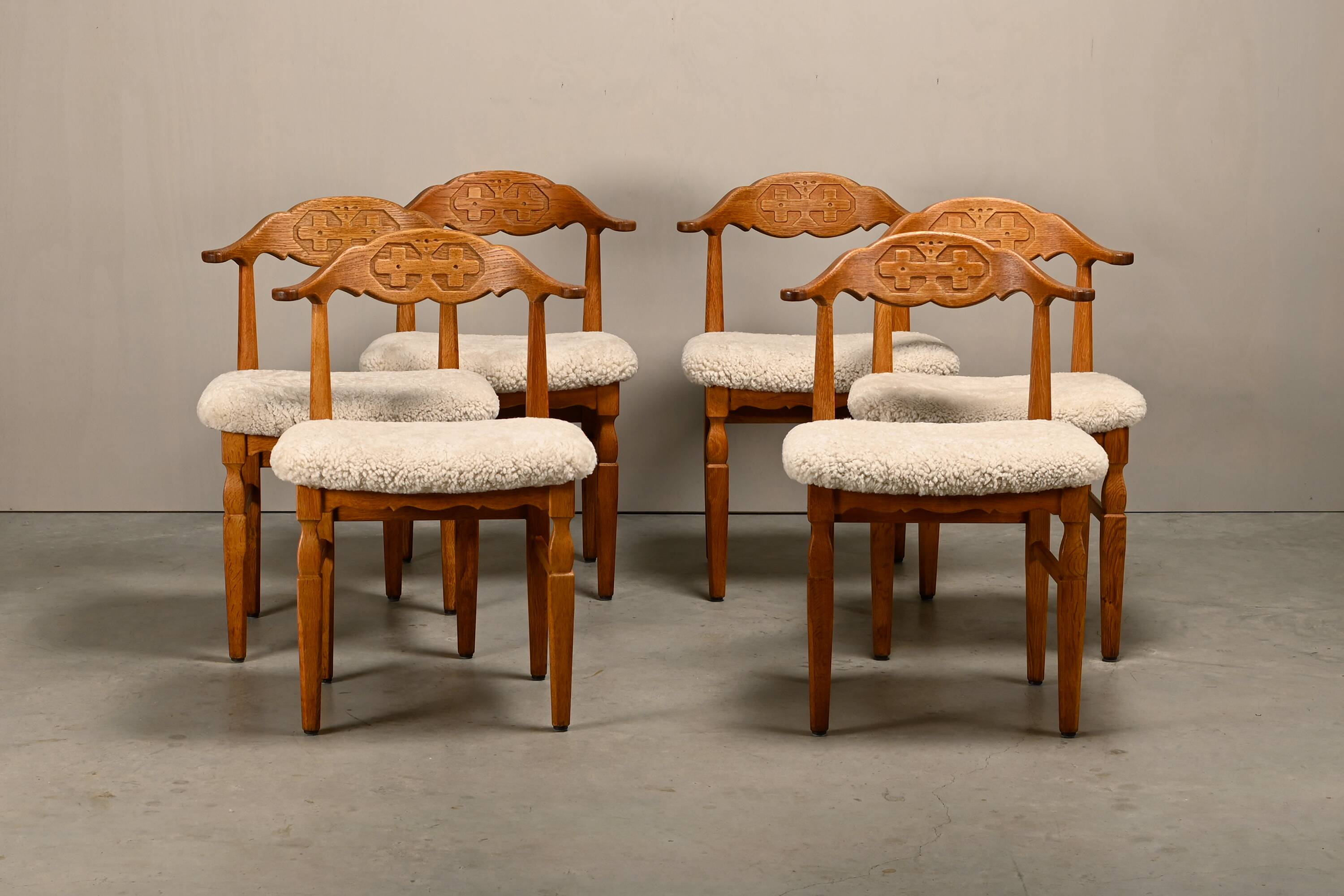 Henning Kjærnulf brutalist dining chairs set in Oak and Sheepskin, Denmark