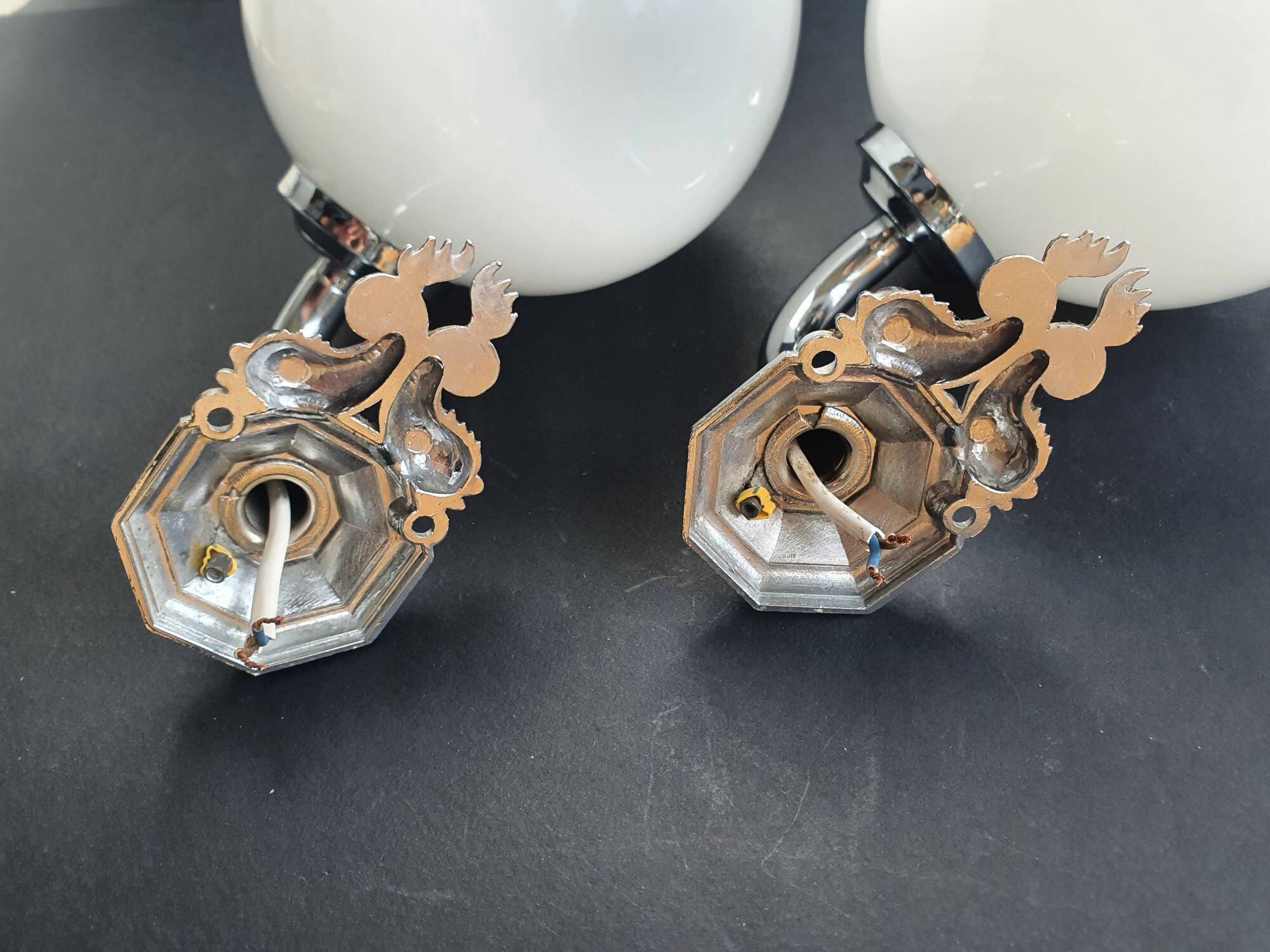 Pair of chrome wall sconces for bathroom with vintage fish pattern.