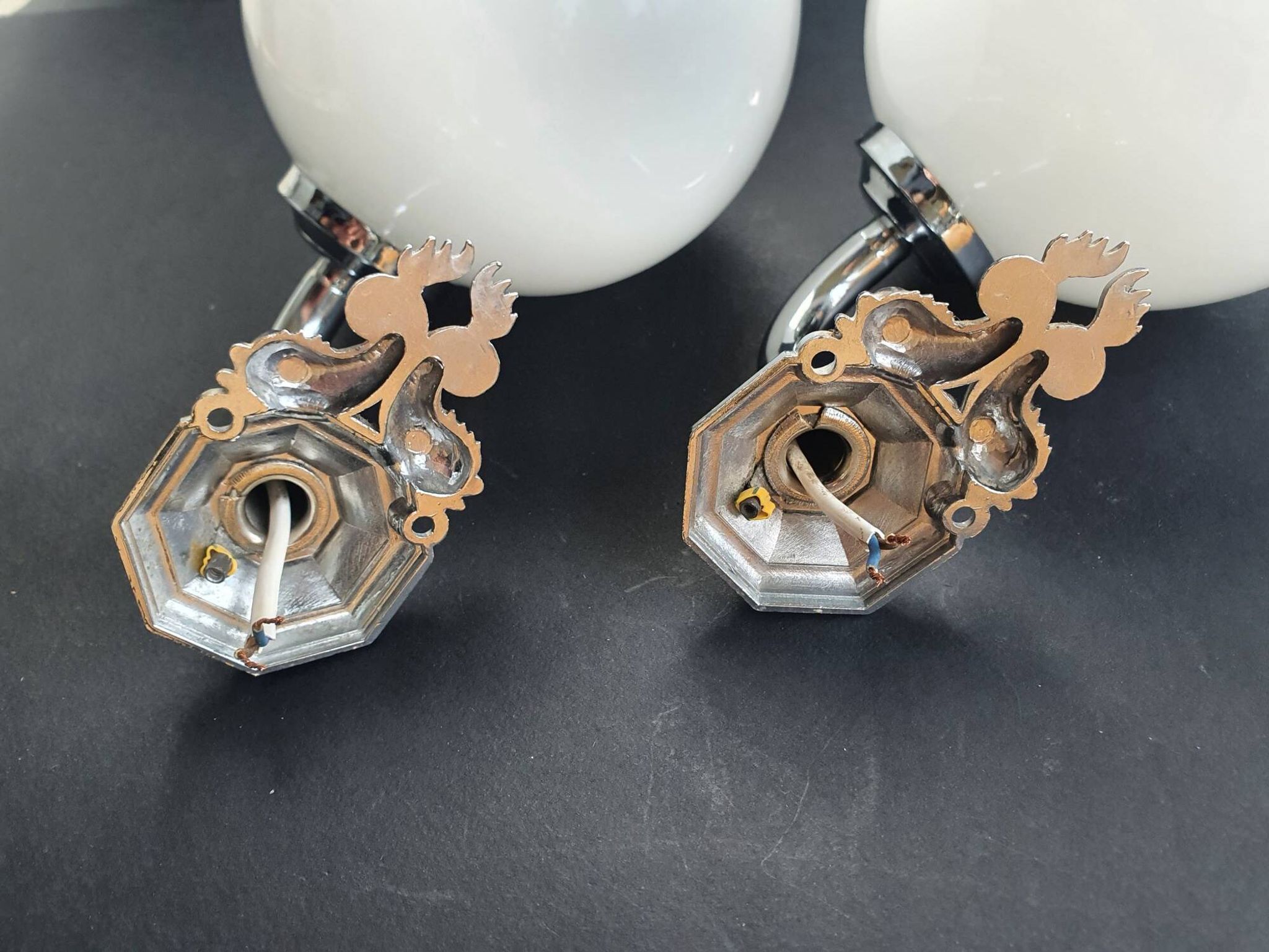 Pair of chrome wall sconces for bathroom with vintage fish pattern.