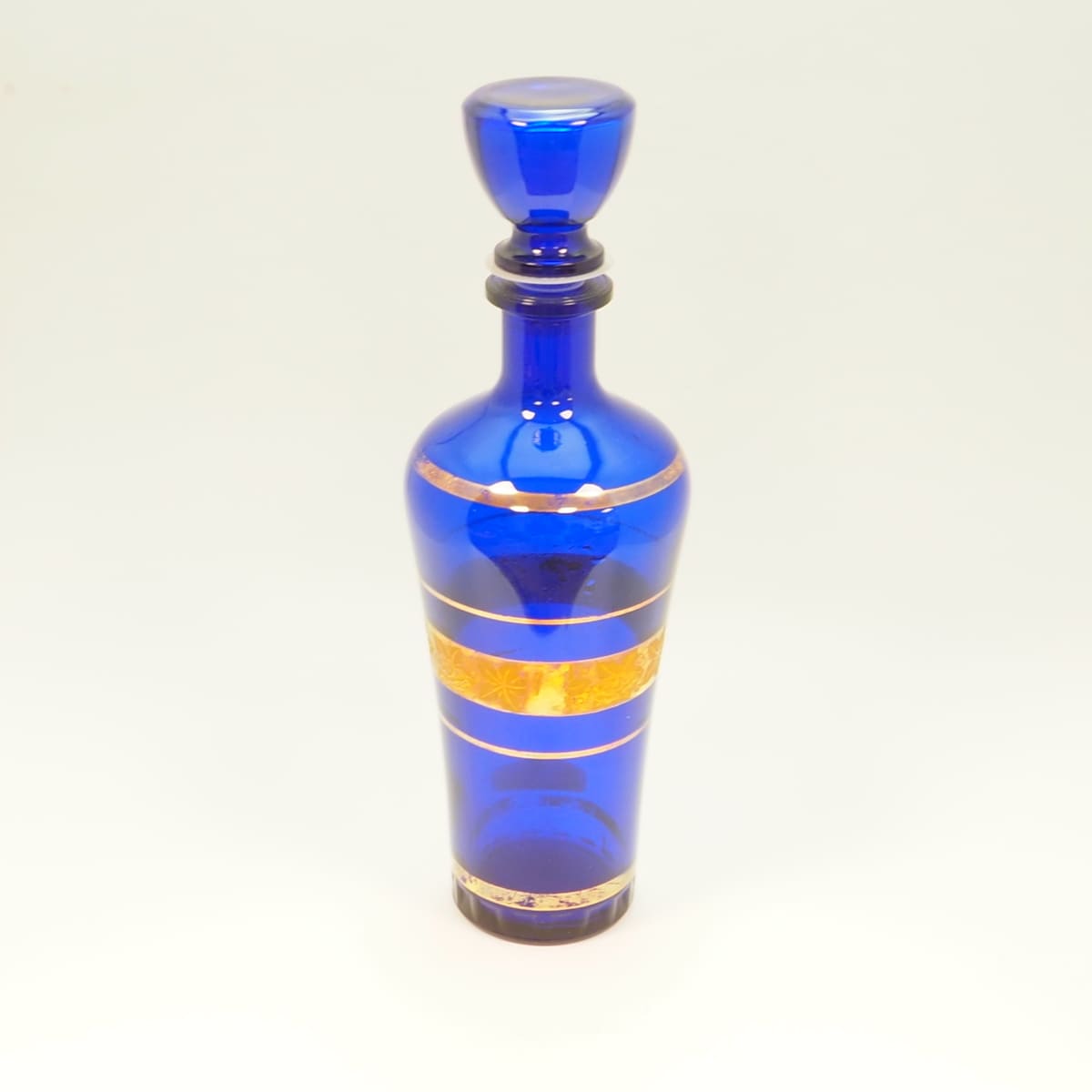 Blue glass decanter with gold decoration