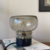 Sciolari table lamp with smoked glass globe and black plastic base.