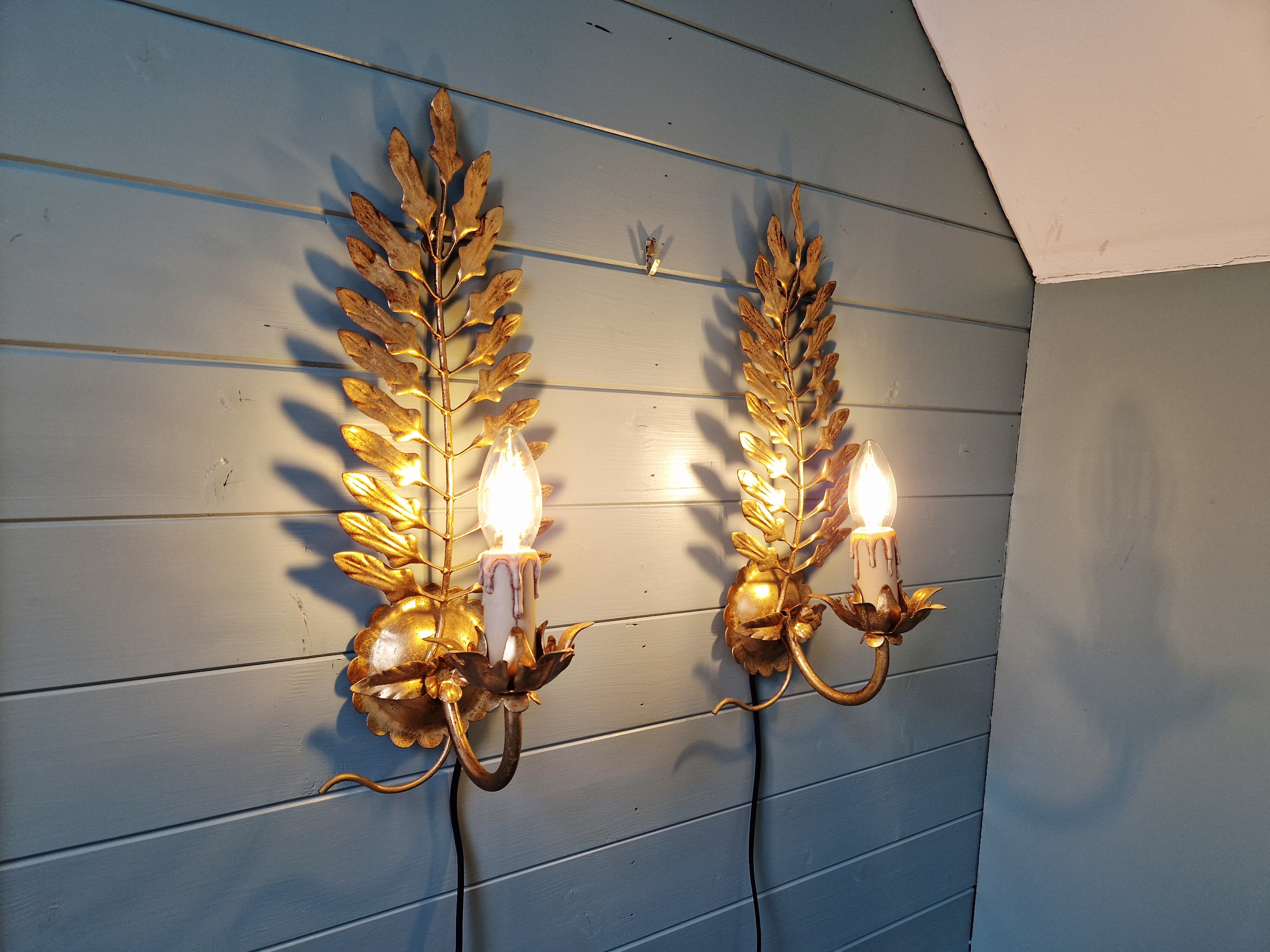 Pair of gold metal wall sconces in Hollywood Regency style, 1970s.