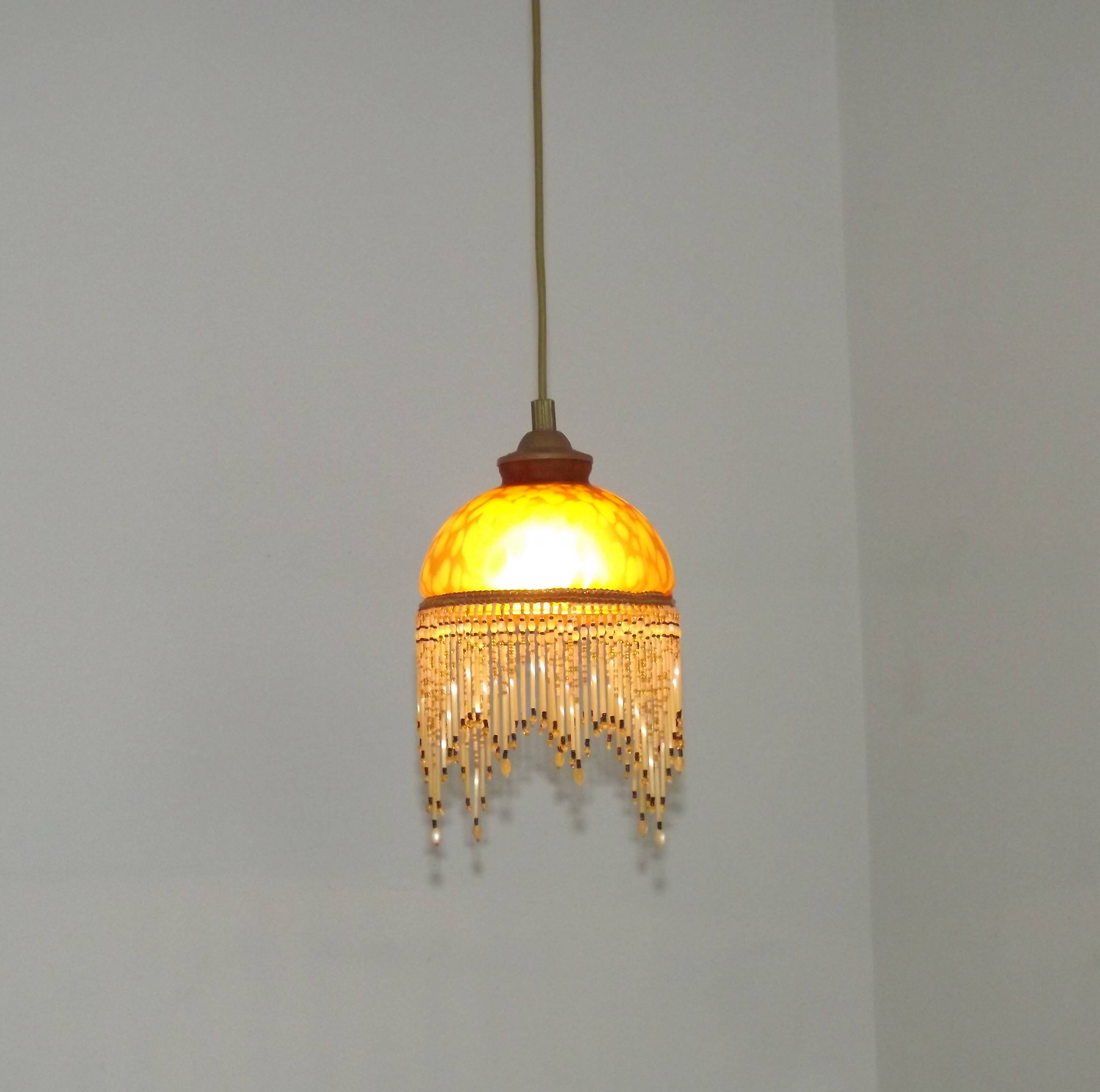 Vintage French amber mottled glass hanging ceiling light with beaded fringe.