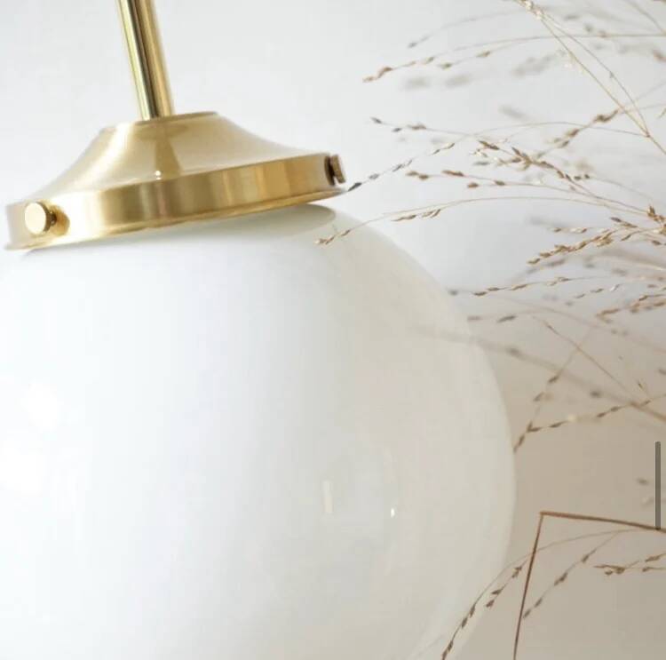 A pair of white opaline and brass suspensions.