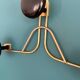 Golden brass coat rack with 3 black vintage hooks from the Mid Century 1950-60.