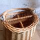 Covered rattan basket for lunch on 50s grass