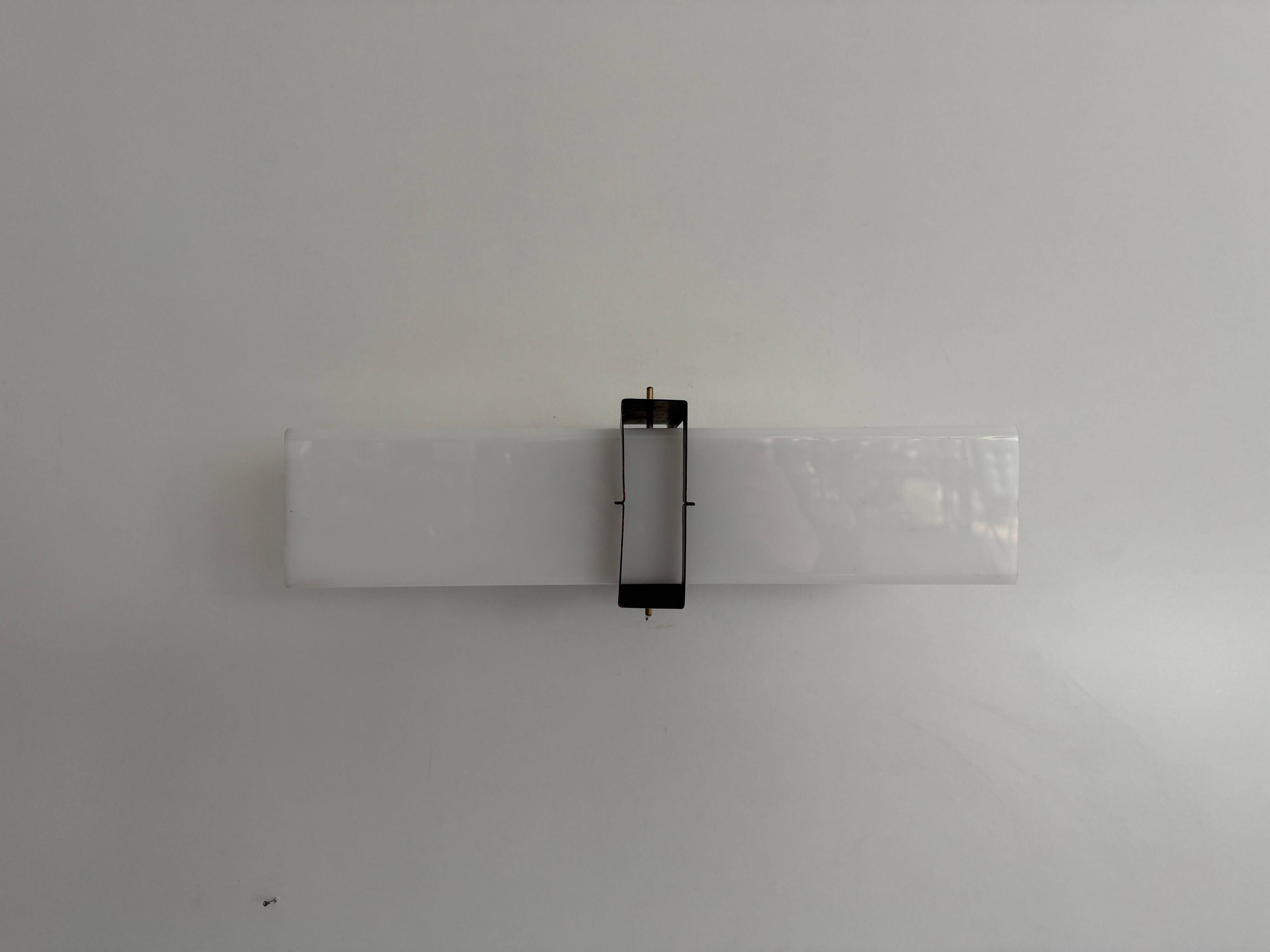 Simple white plexiglass wall light with a black metal frame, 1970s, Germany.