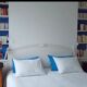 Gustavian style headboard in white wood with linen upholstery
