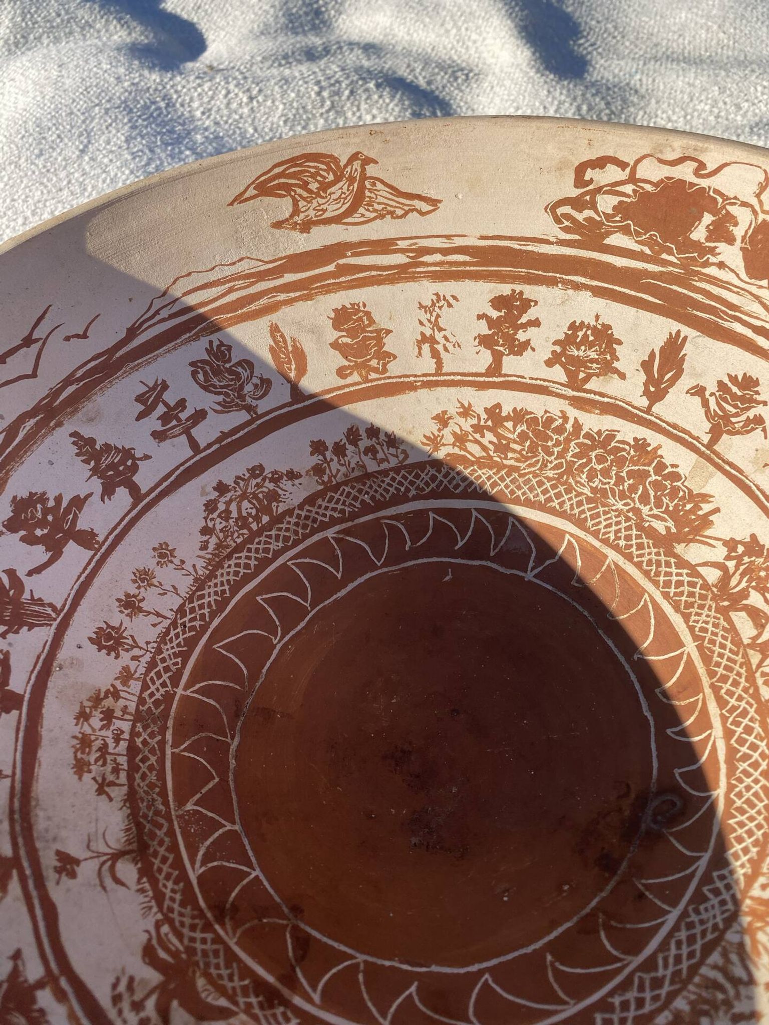Large shallow terracotta dish decorated with birds, 20th century.