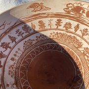 Large shallow terracotta dish decorated with birds, 20th century.