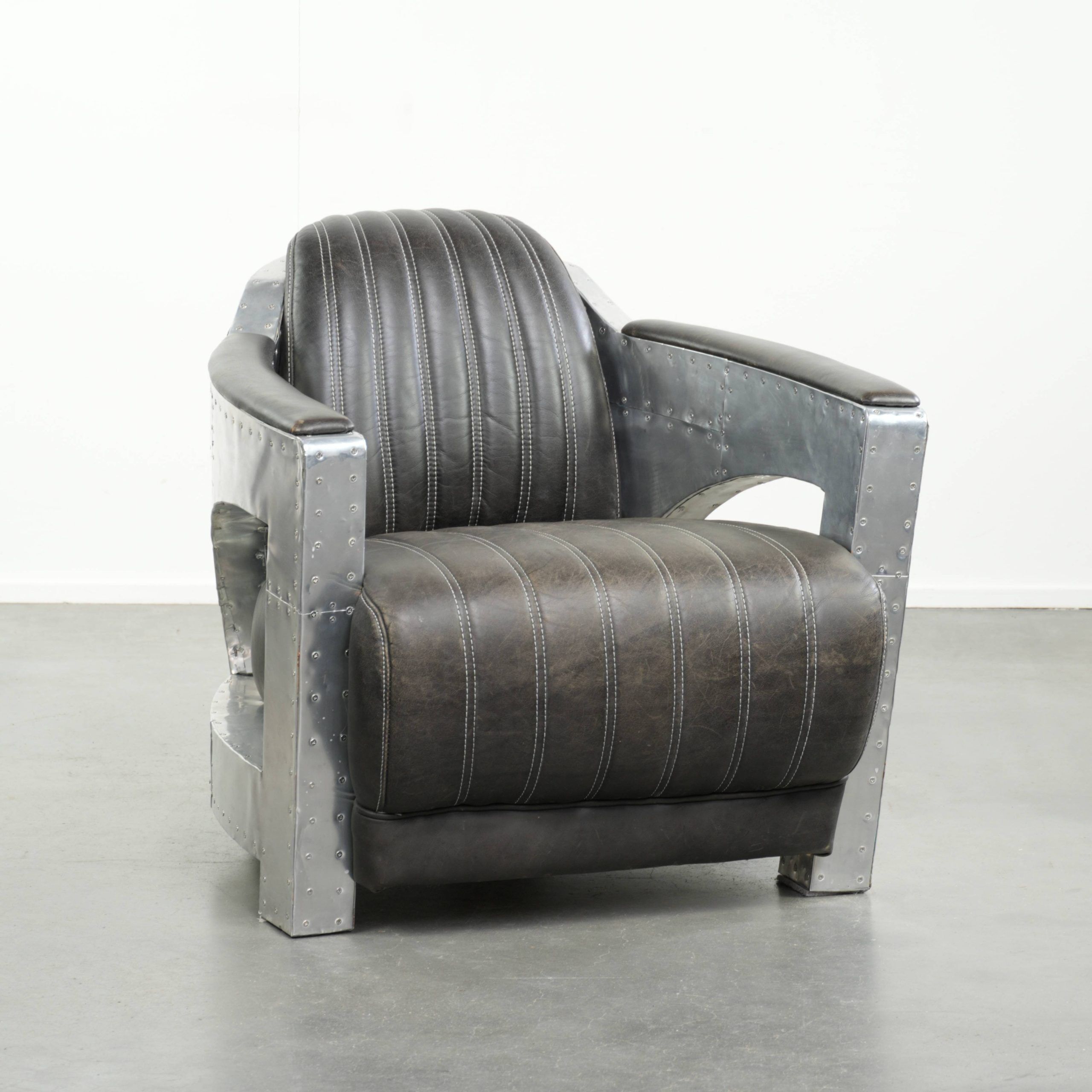 Cow leather aviator design armchair finished with aluminium and rivets