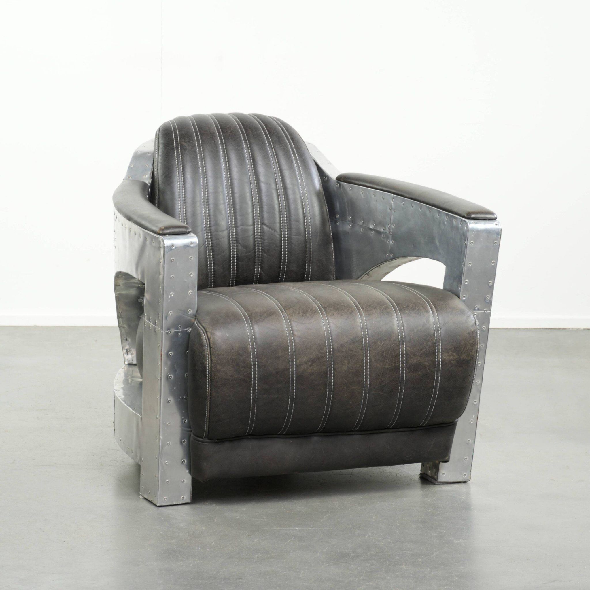 Cow leather aviator design armchair finished with aluminium and rivets