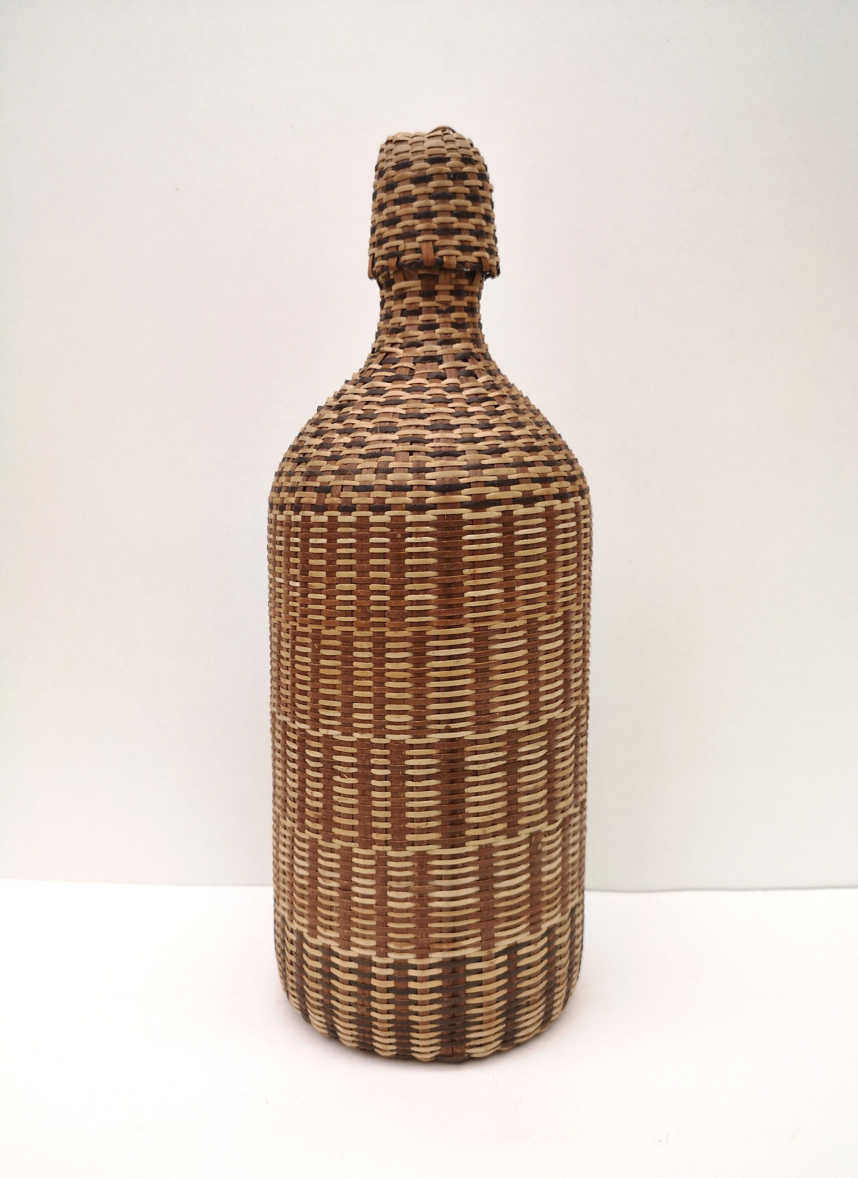 Vintage bottle in braided straw