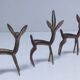 five vintage brass sculptures of gazelles, antelopes, and a giraffe