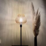 Table lamp with an antique textured globe and a golden base