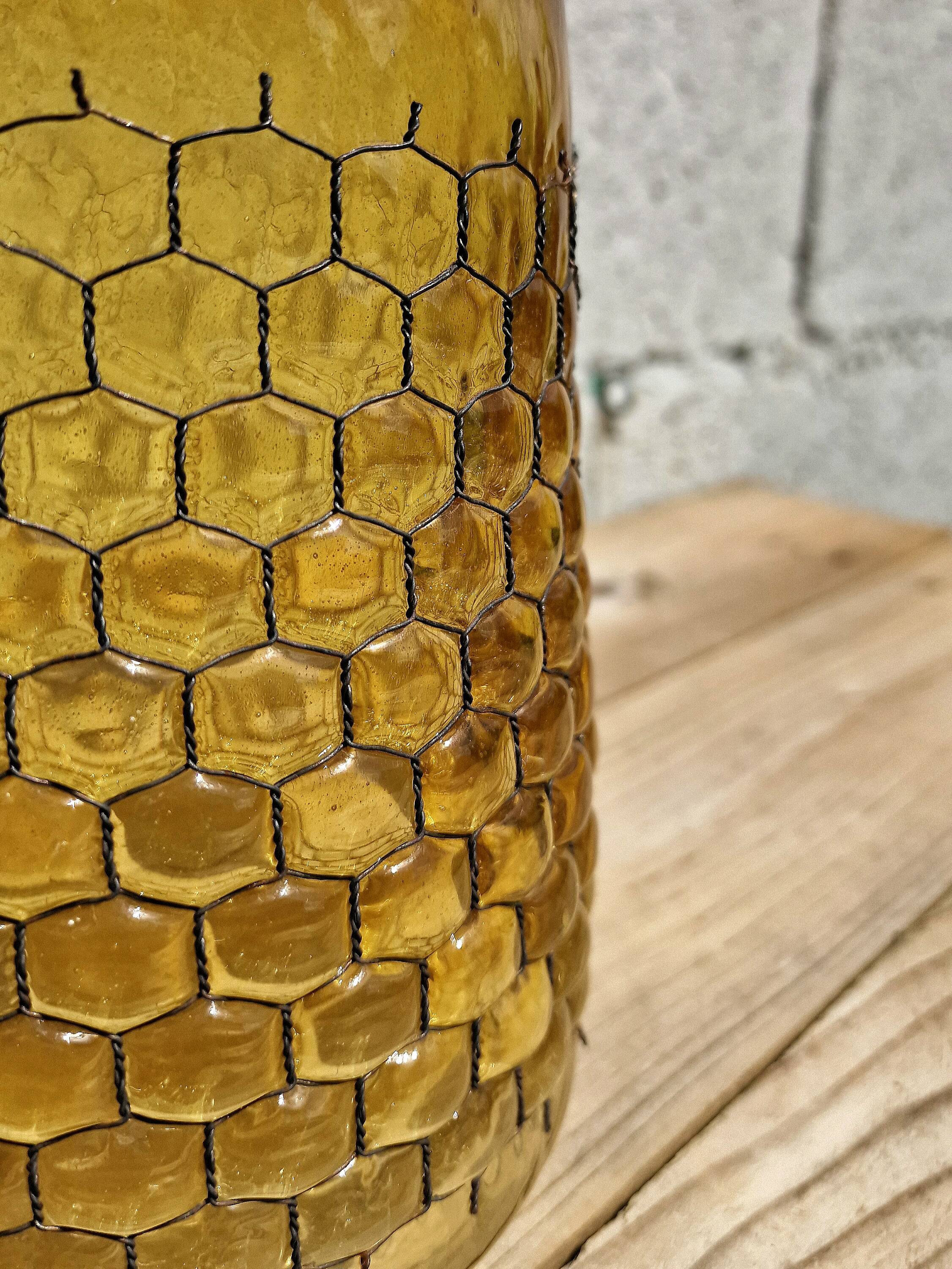Artisanal blown amber glass vase with integrated honeycomb structure.