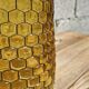 Artisanal blown amber glass vase with integrated honeycomb structure.