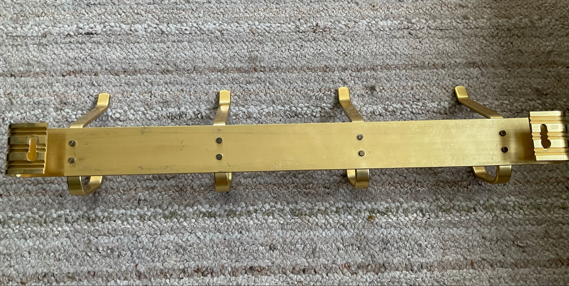Golden wall-mounted coat rack from the 70s.