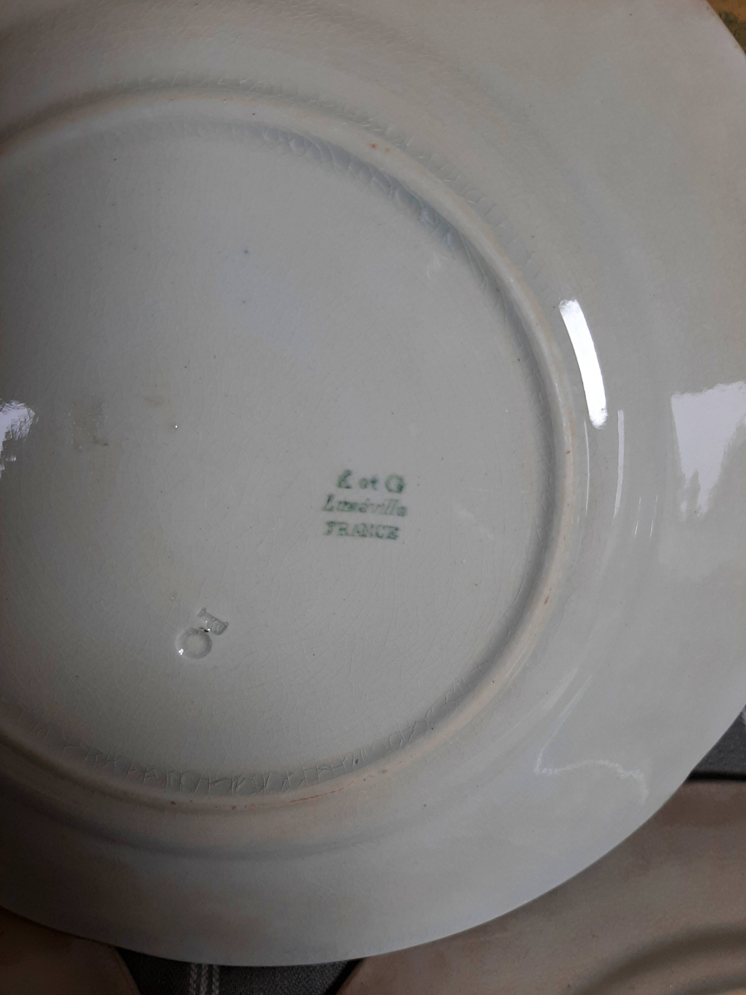 Antique earthenware plates with fruit decoration.