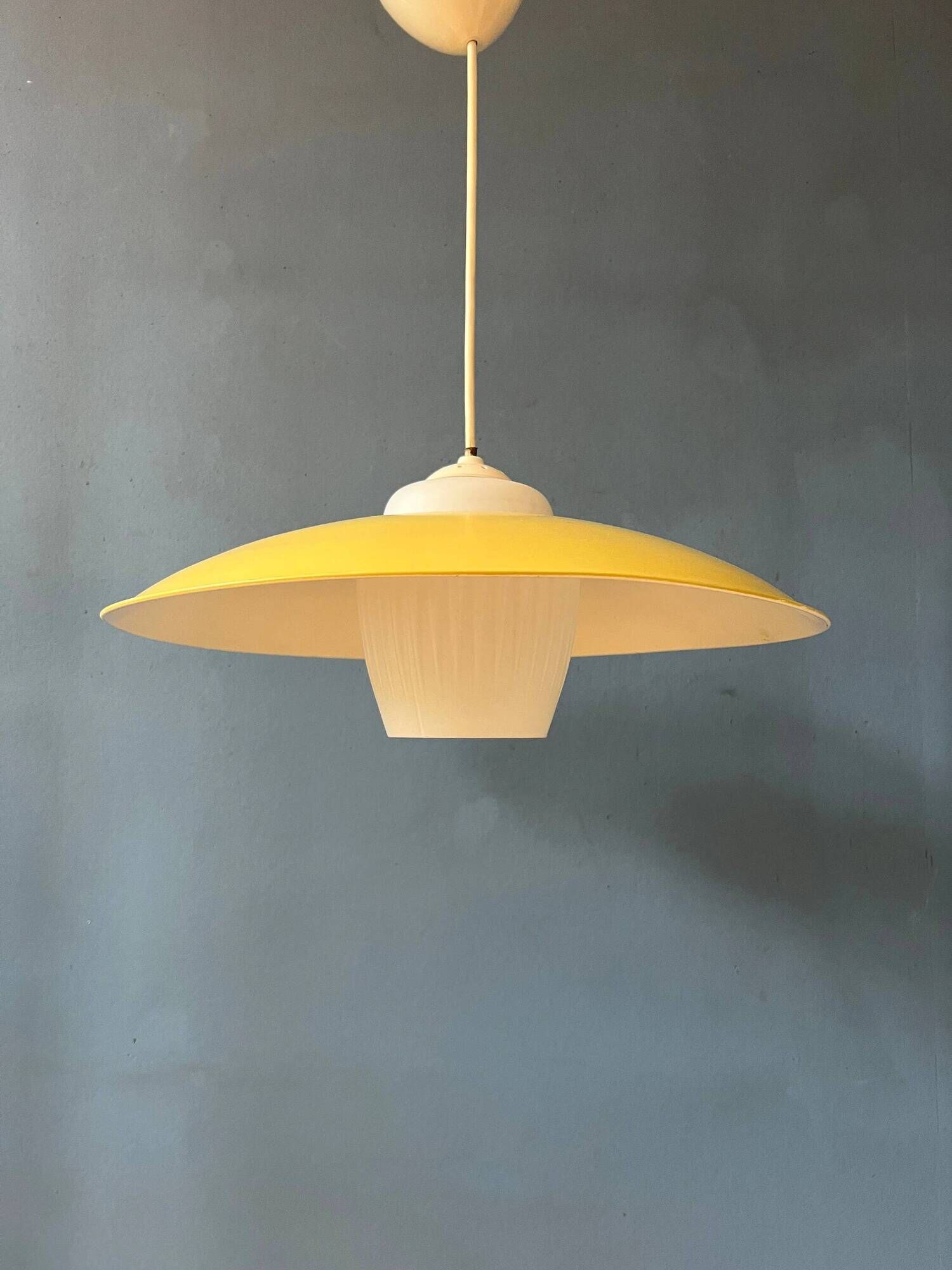 Danish mid-century suspension with opaline glass shade and yellow metal cover.