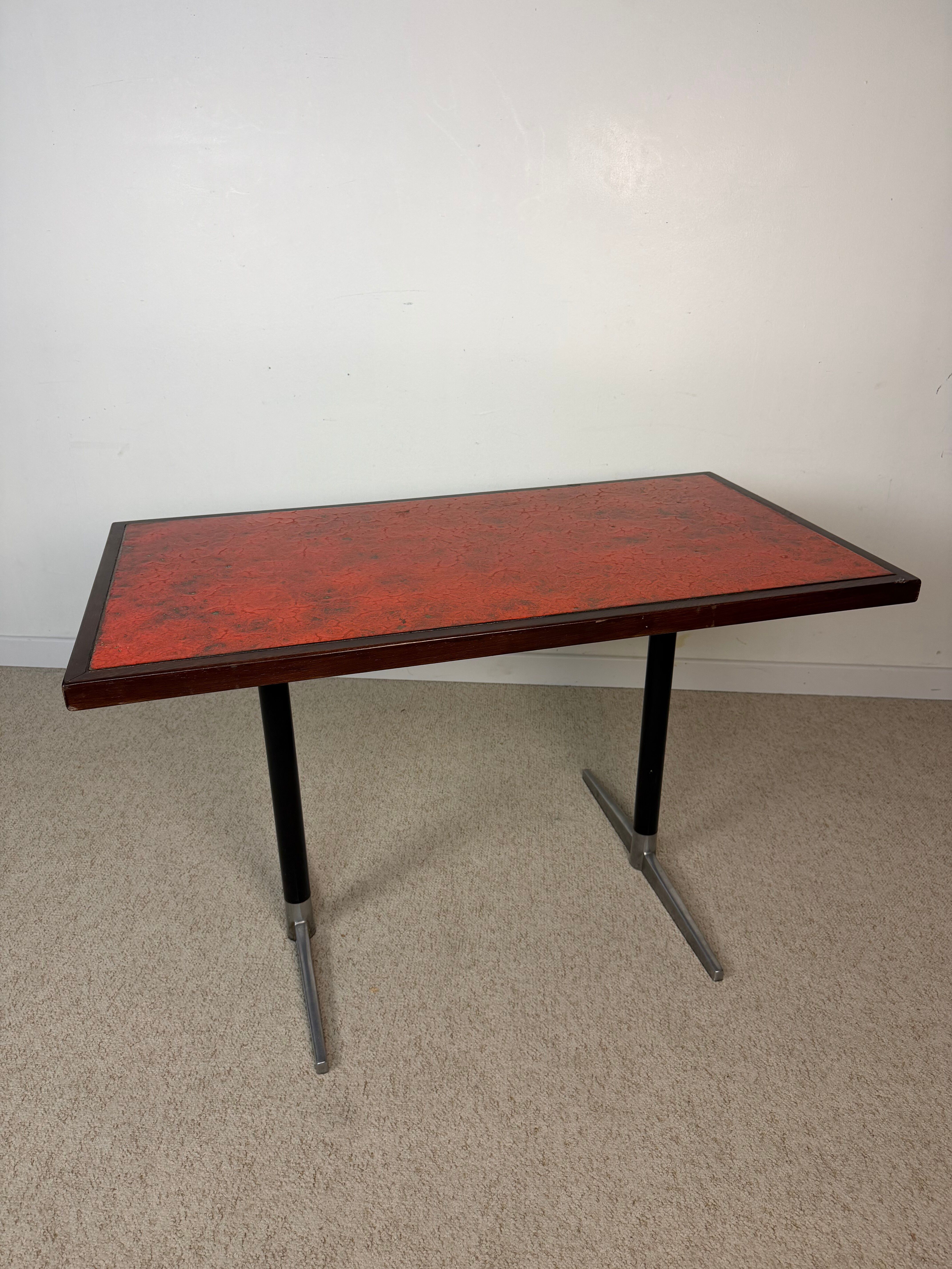 Vintage bistro table with orange-red ceramic.