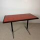 Vintage bistro table with orange-red ceramic.