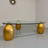 Vintage Italian design coffee table with a glass top and gold base, dating from the 1980s.