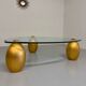 Vintage Italian design coffee table with a glass top and gold base, dating from the 1980s.