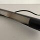 Minimalist black metal wall light with a cylindrical design, 1960s, Germany.