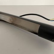 Minimalist black metal wall light with a cylindrical design, 1960s, Germany.