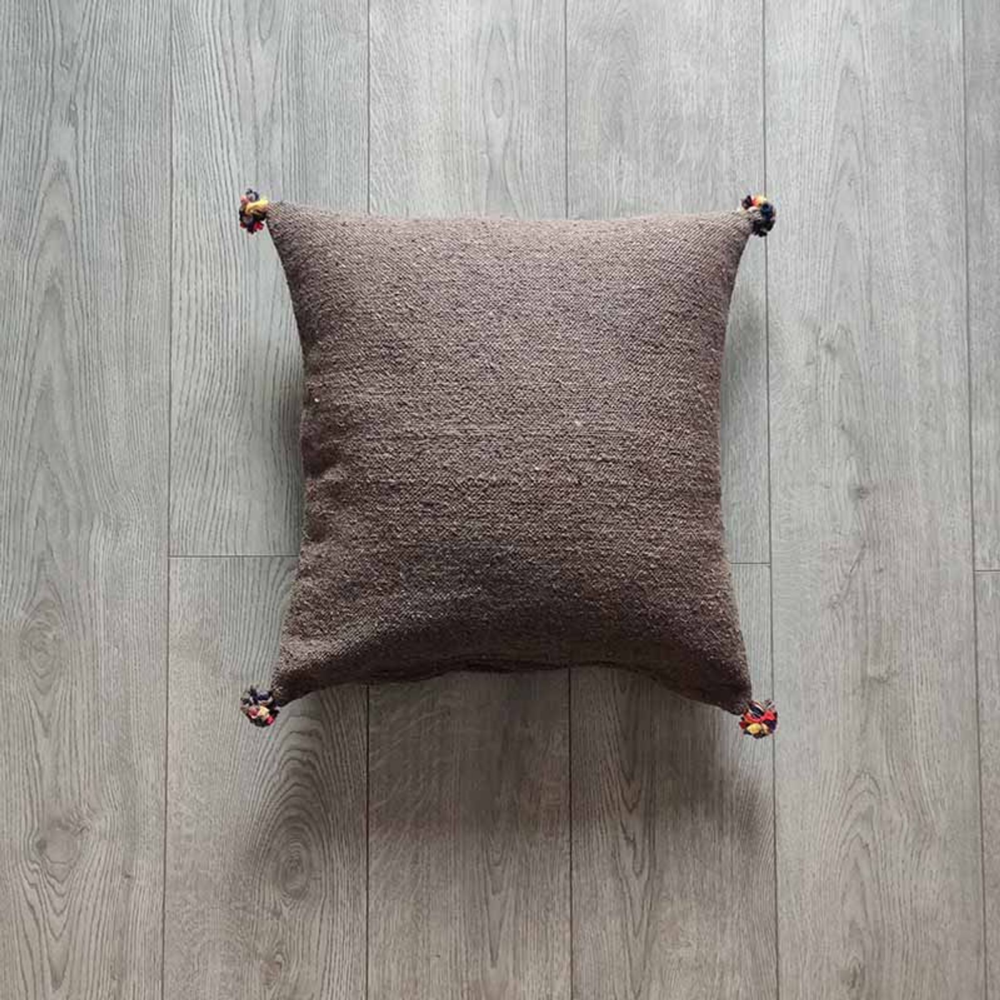 Moroccan brown cushion with cotton pompom