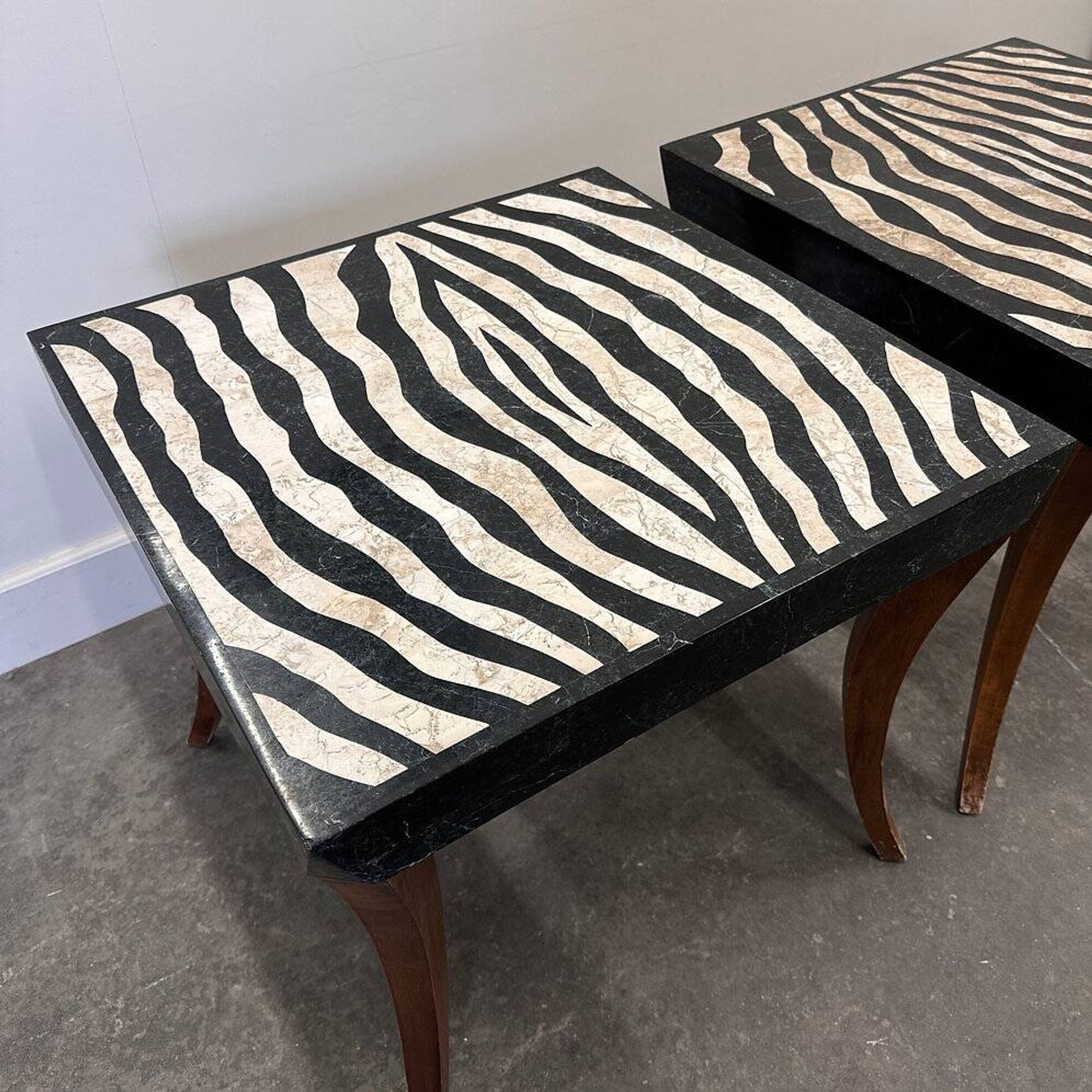 Striking pair of Italian zebra inlaid tessellated stone tables with refined curves