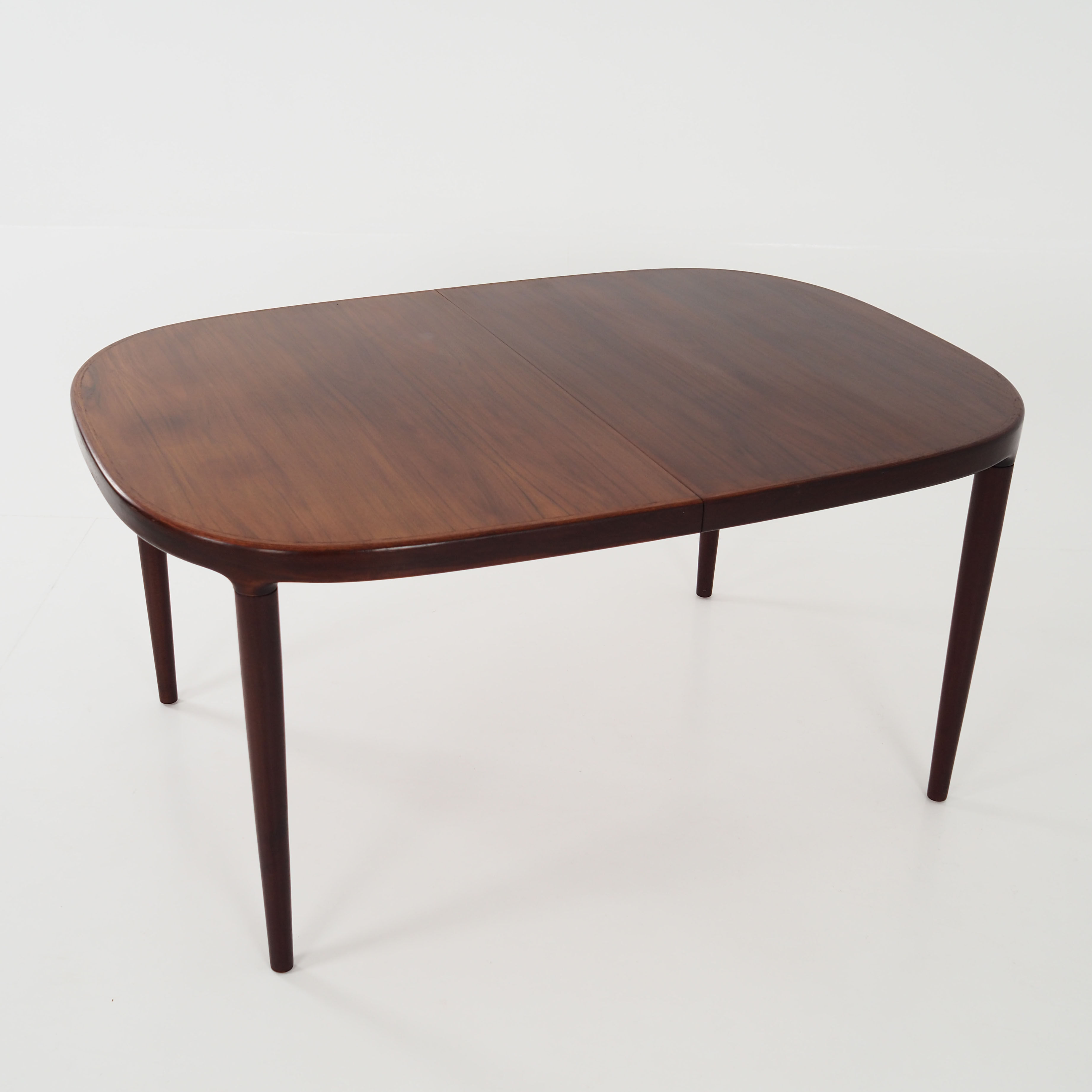 Oval table, covered with rosewood veneer.Design of the 70s