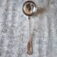 The Christofle silver-plated “Vendôme” cream ladle features a design