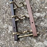 Coat rack, teak and brass coat hooks.