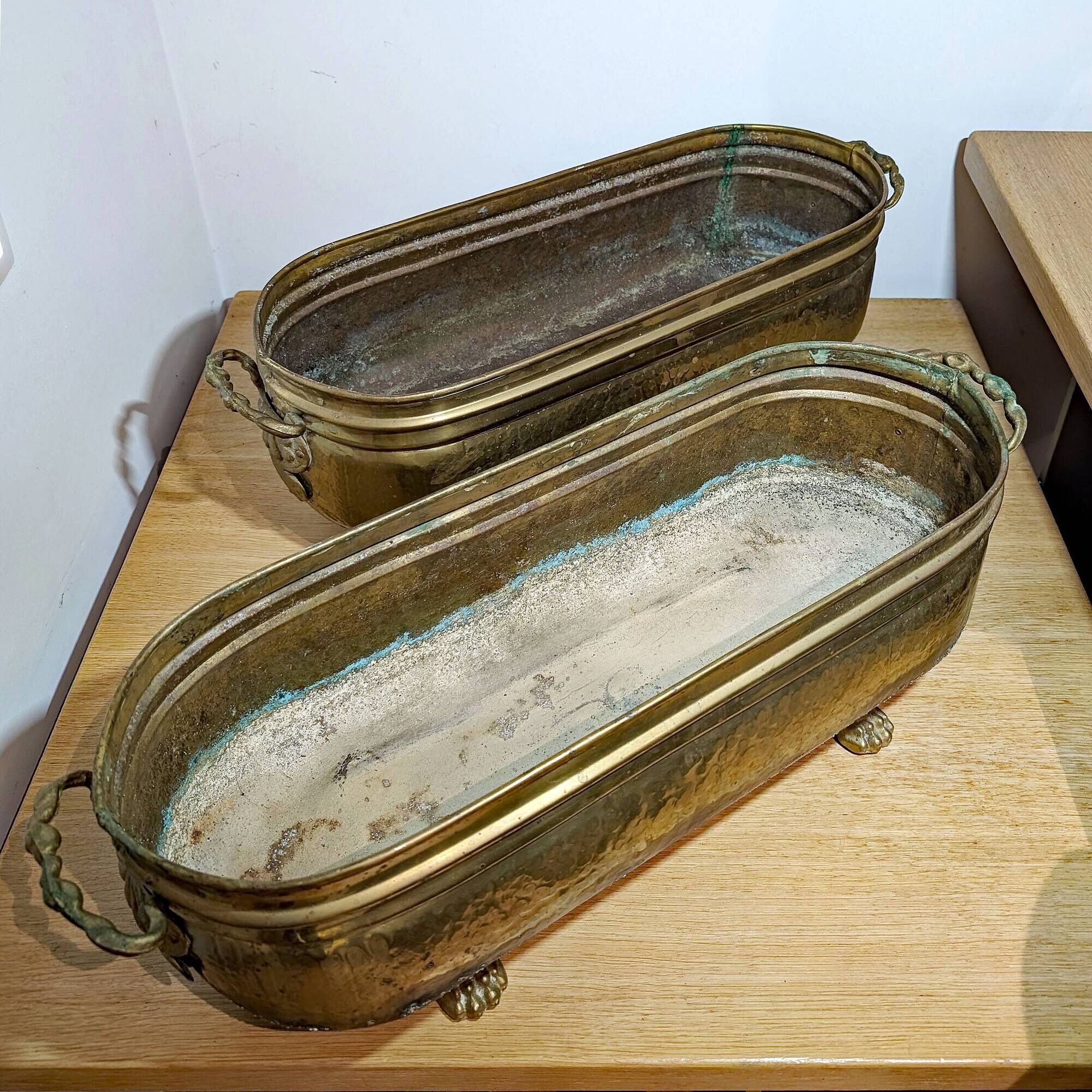 Pair of large antique planters with lion's paw feet.