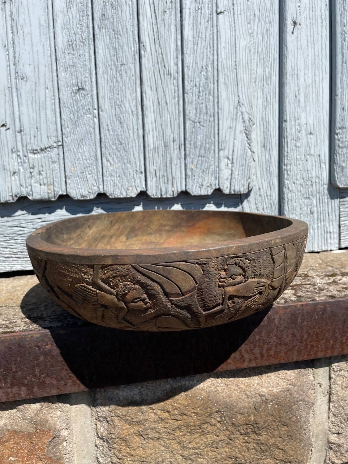 Old carved wooden bowl with African decoration.
