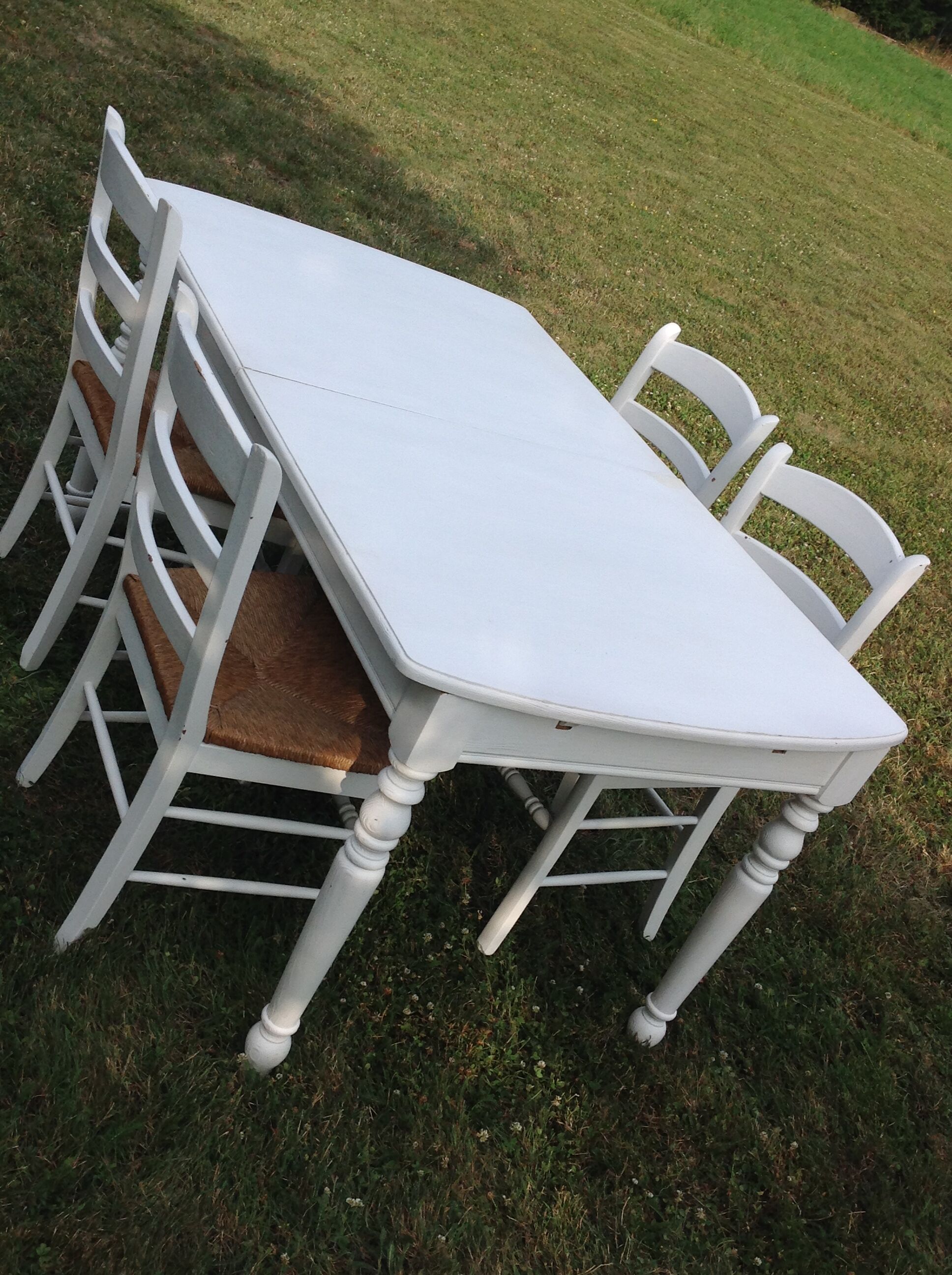 White farmhouse table set and four chairs