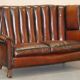Victorian leather canapé and armchair, barrel back, circa 1860, restored.