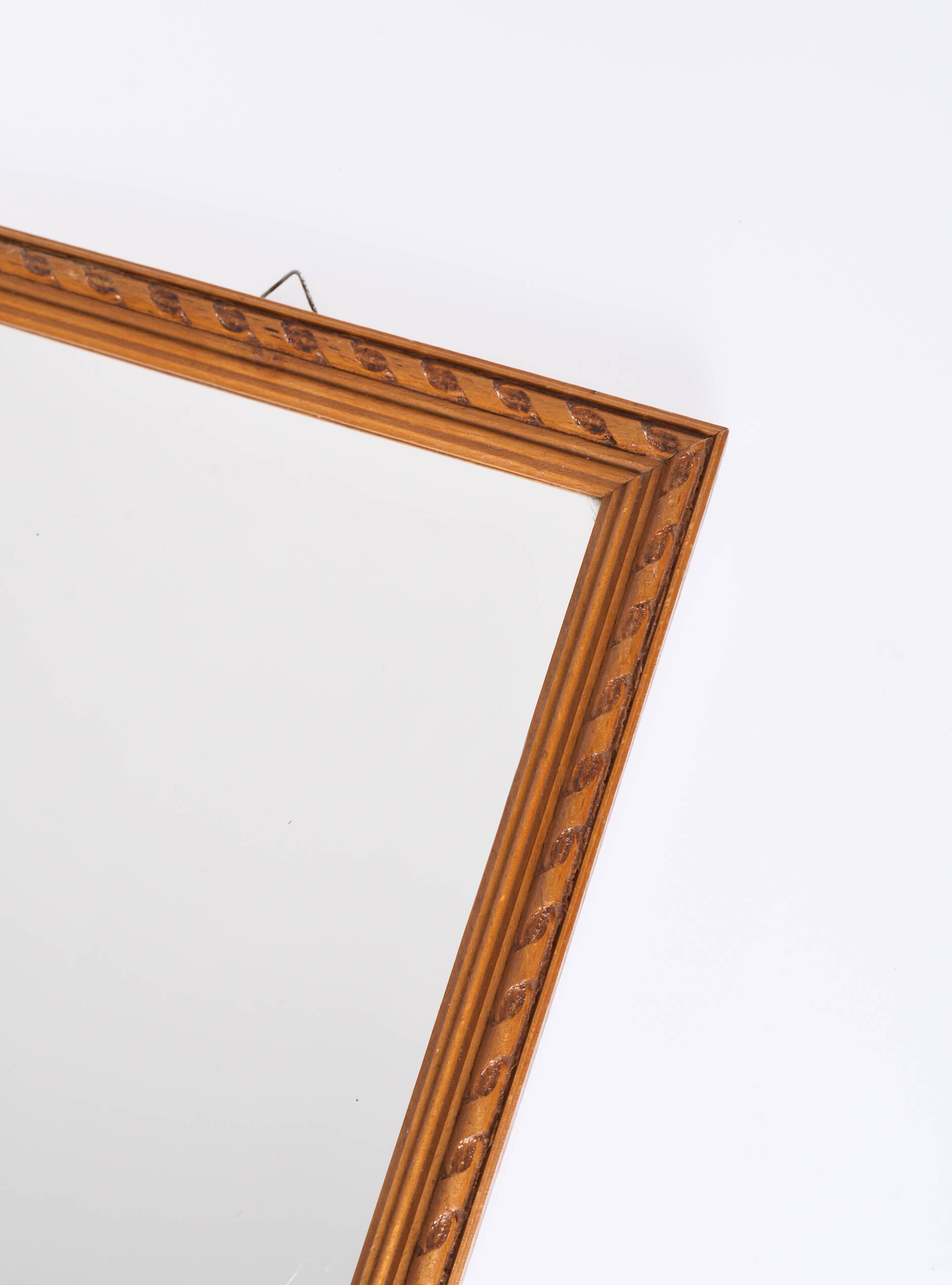 Small old wooden mirror with carved frame