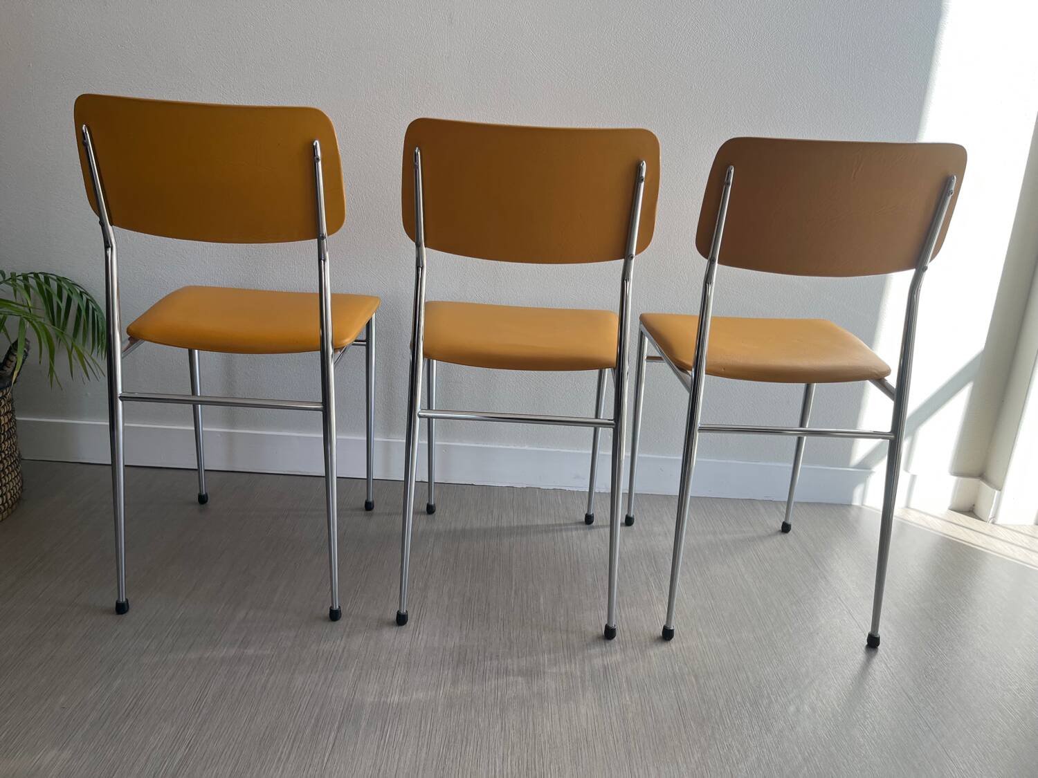 LM vintage chrome and orange/mustard yellow faux leather chairs