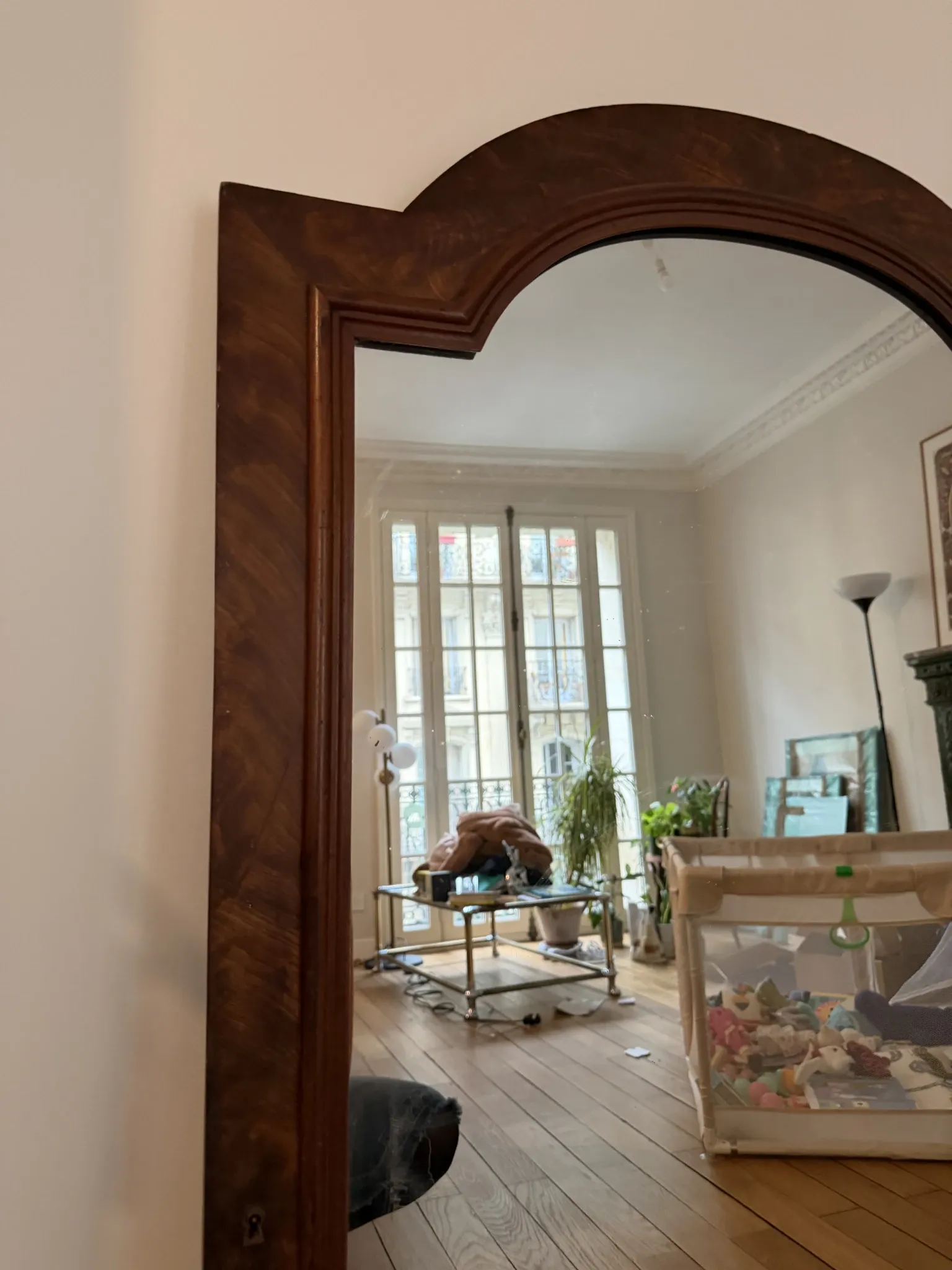 Large curved mirror with a wooden frame