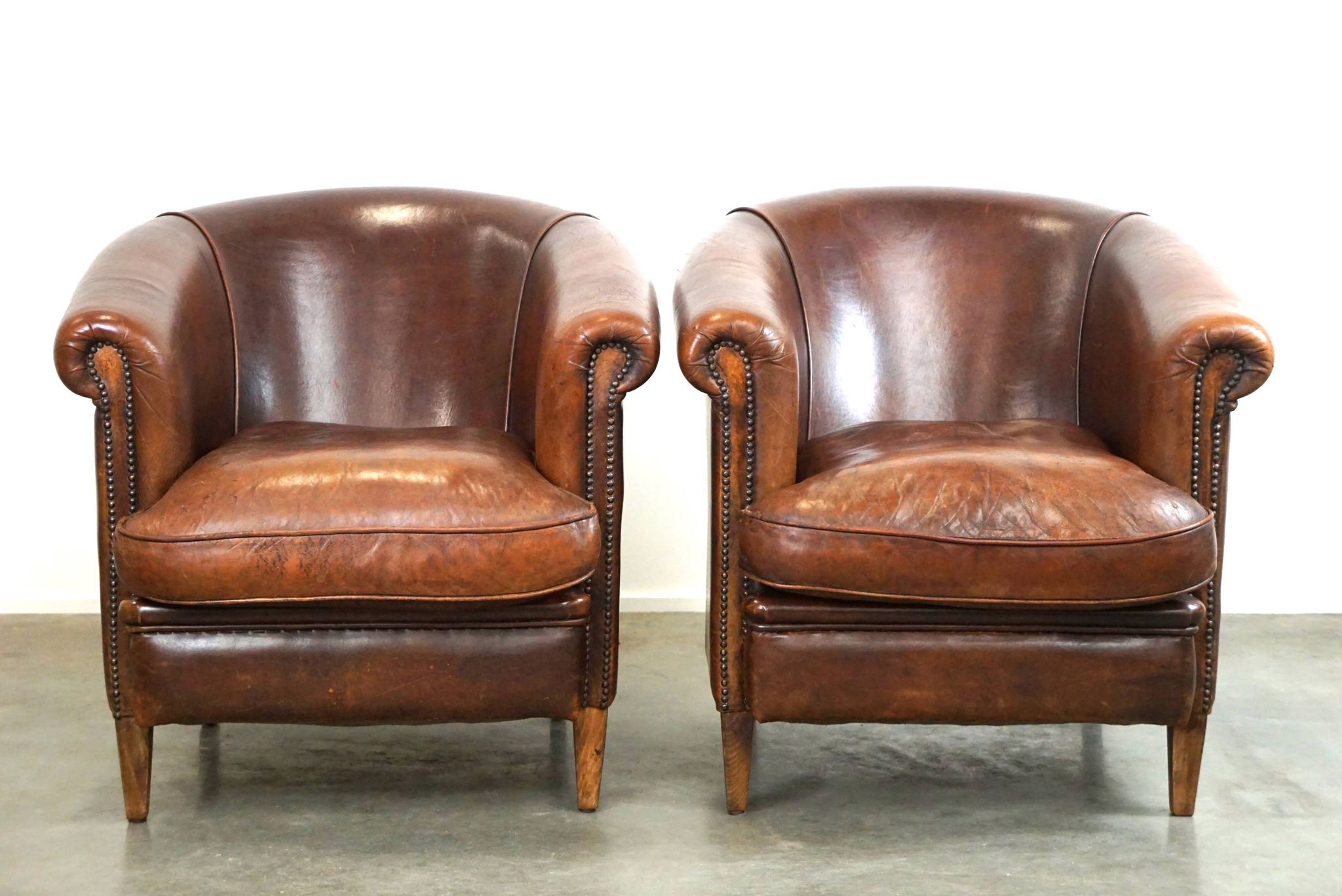 Set of two rugged sheep let of two rugged sheep leather club armchairs with a nice distressed look