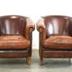 Set of two rugged sheep let of two rugged sheep leather club armchairs with a nice distressed look