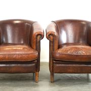Set of two rugged sheep let of two rugged sheep leather club armchairs with a nice distressed look