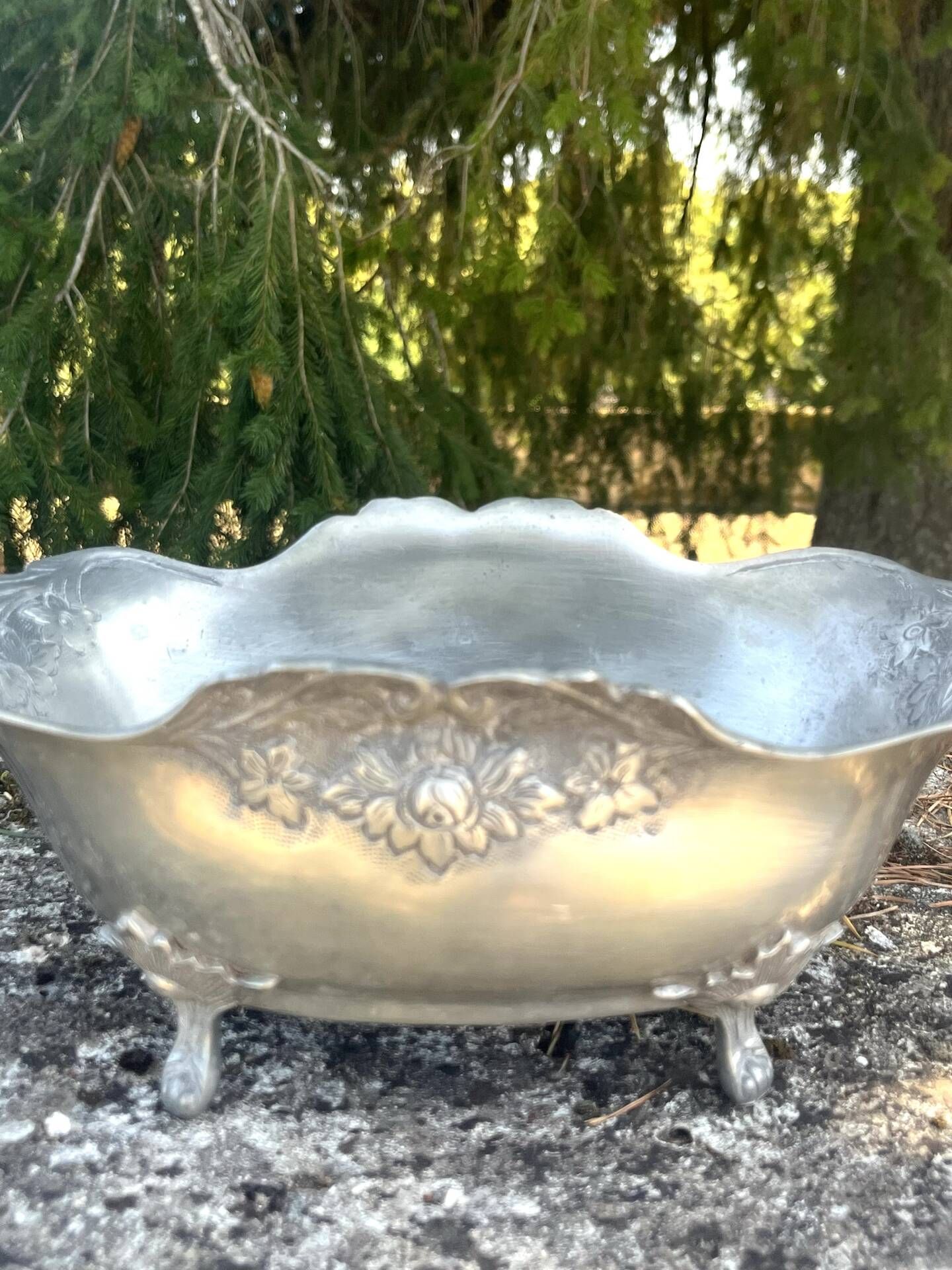 Footed pewter champagne cooler on claw feet with floral relief