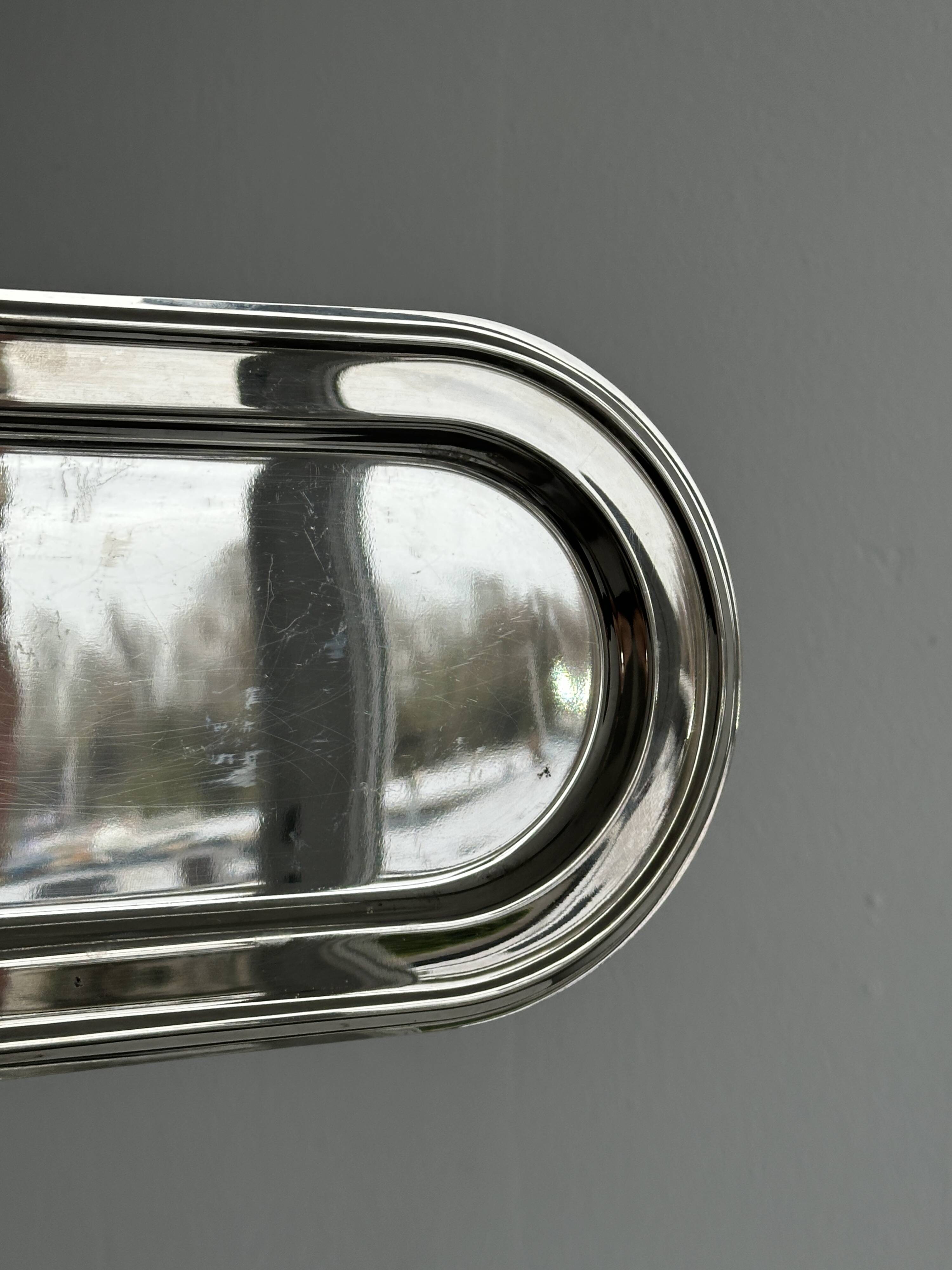 Small oval tray in shiny lightweight metal.