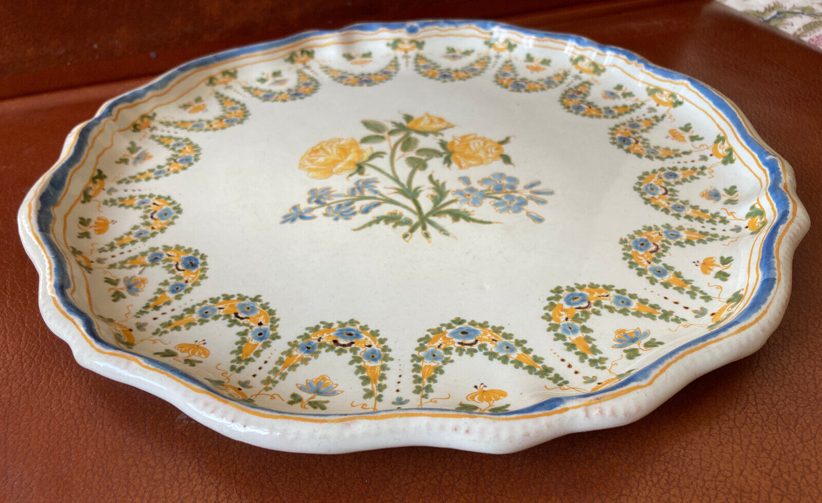 Old round dish in Lyon faience decorated with yellow roses