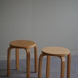 Alvar Aalto, a pair of vintage birch stools, model "60", made by Artek, 1970s.