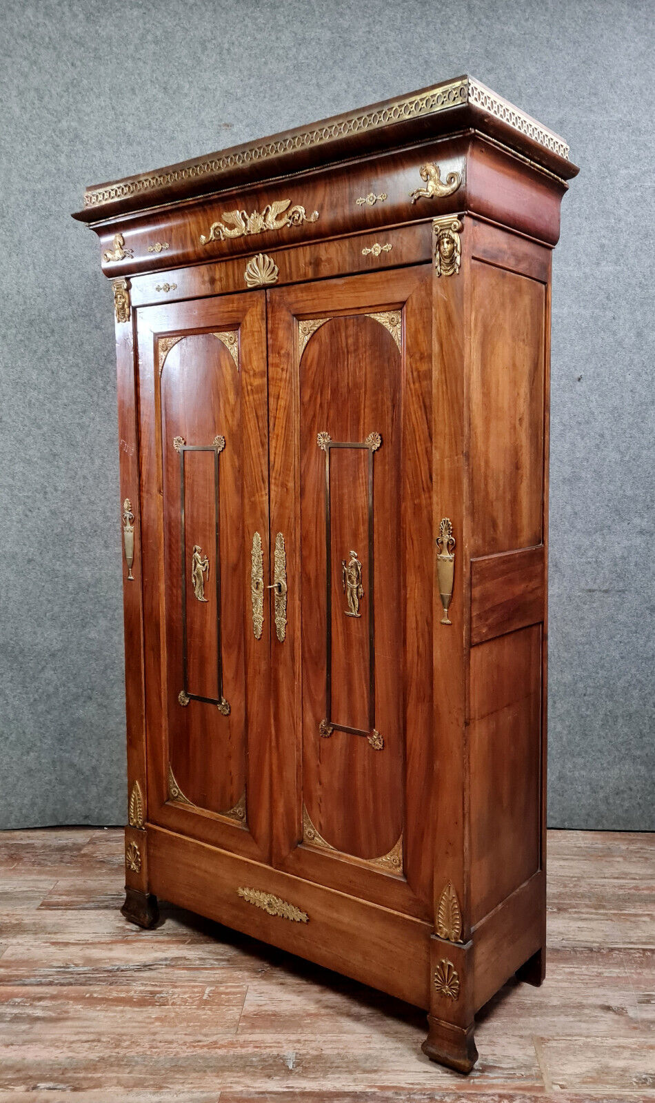 Louis Philippe period wardrobe (nineteenth) entirely covered with gilded bronzes